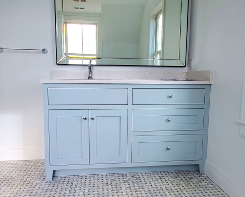 Custom bathroom vanity with tile floor and mirror