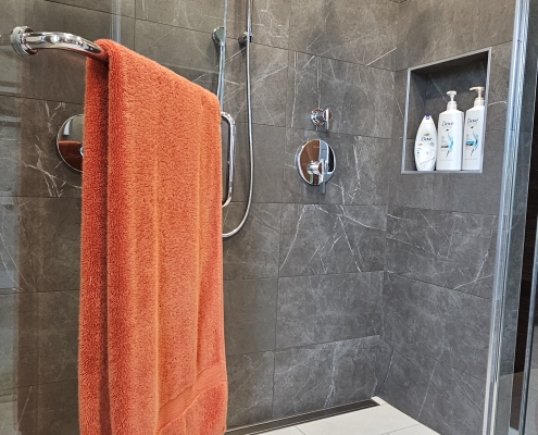 towel hanging in custom tile shower
